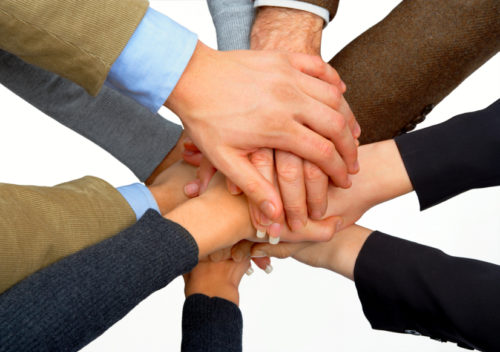 Photograph of multiple hands holding | NLP World.